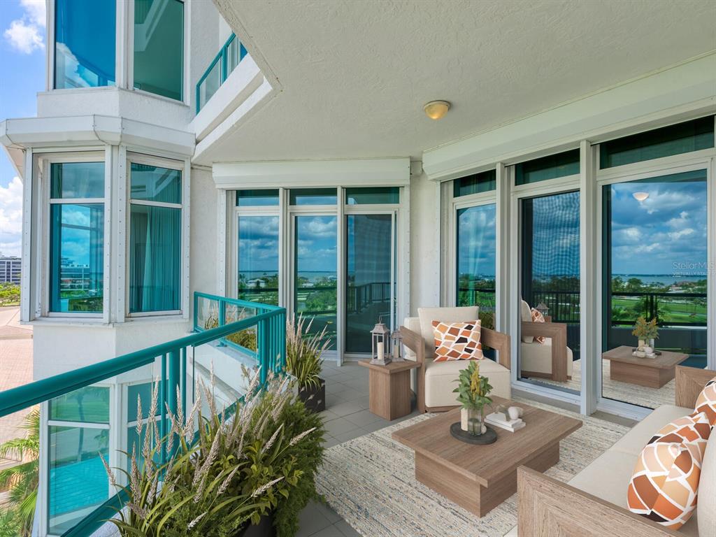 655 Longboat Club Road, Unit 16B Longboat Key, FL 34228 - Photo 25 of 50 a living room with furniture and floor to ceiling windows
