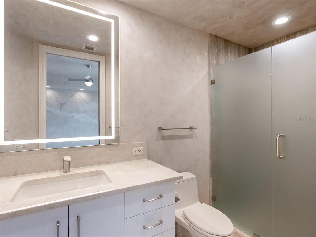 655 Longboat Club Road, Unit 16B Longboat Key, FL 34228 - Photo 28 of 50 a bathroom with a sink toilet vanity and tub