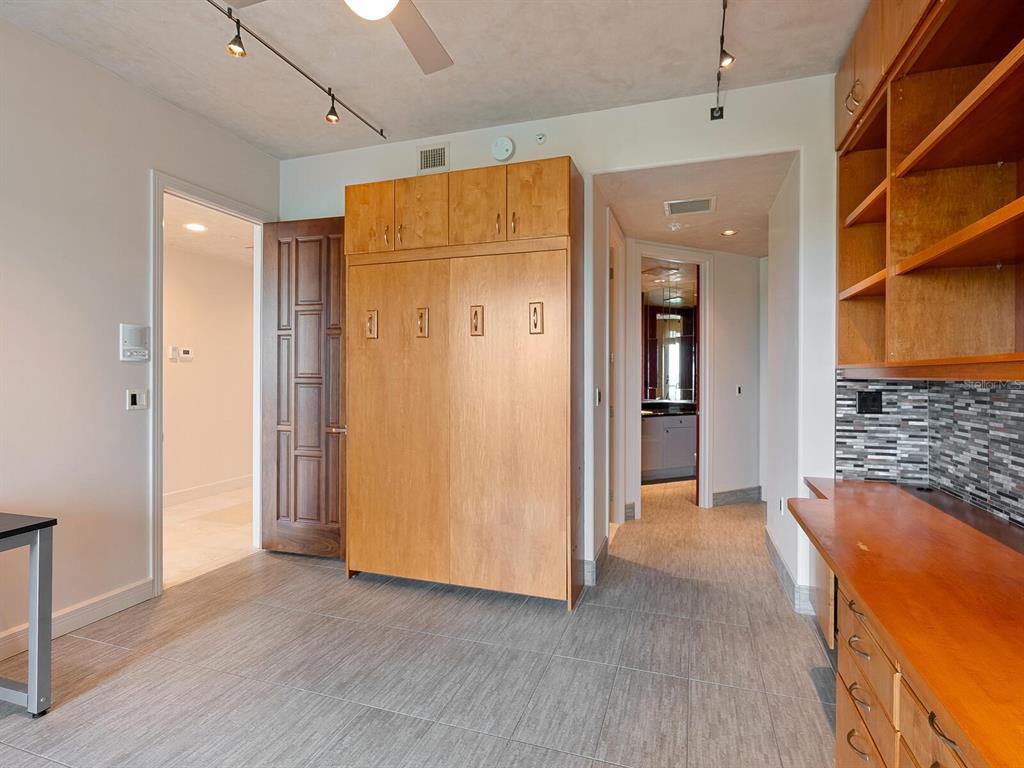 655 Longboat Club Road, Unit 16B Longboat Key, FL 34228 - Photo 30 of 50 an empty room with wooden floor and a bathroom