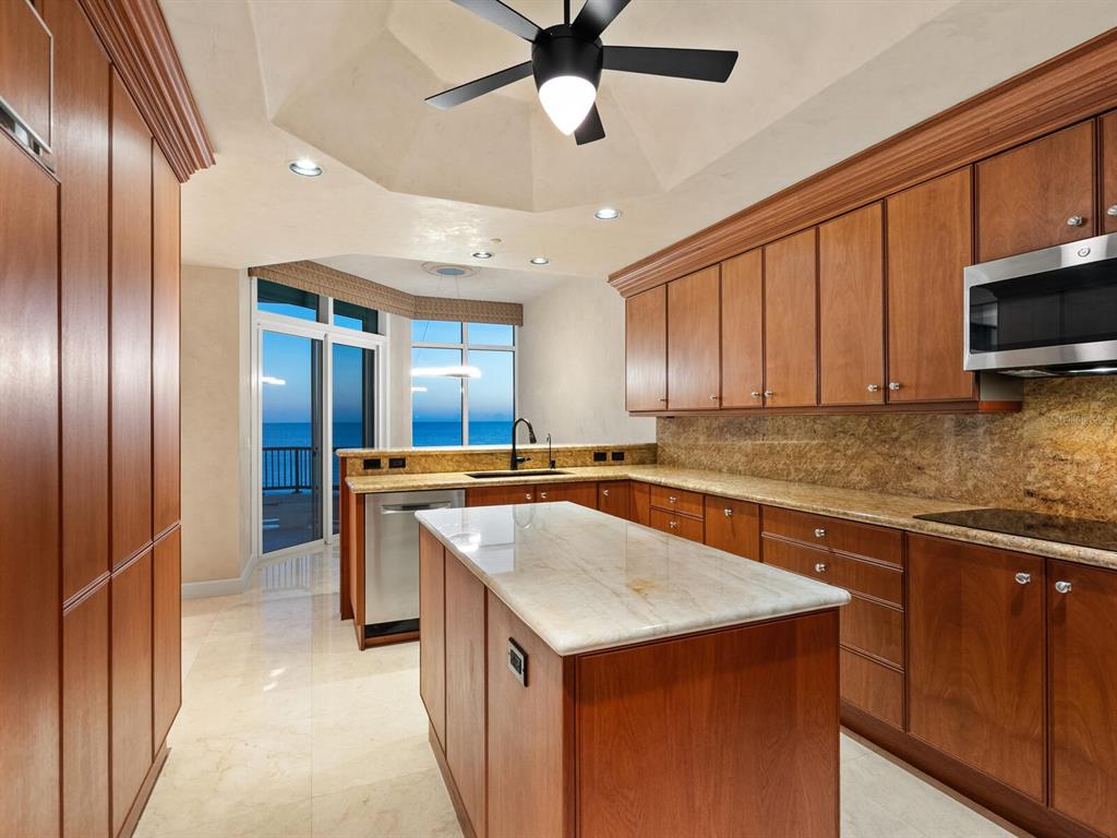 655 Longboat Club Road, Unit 16B Longboat Key, FL 34228 - Photo 42 of 50 a kitchen with stainless steel appliances granite countertop a sink a stove and a refrigerator