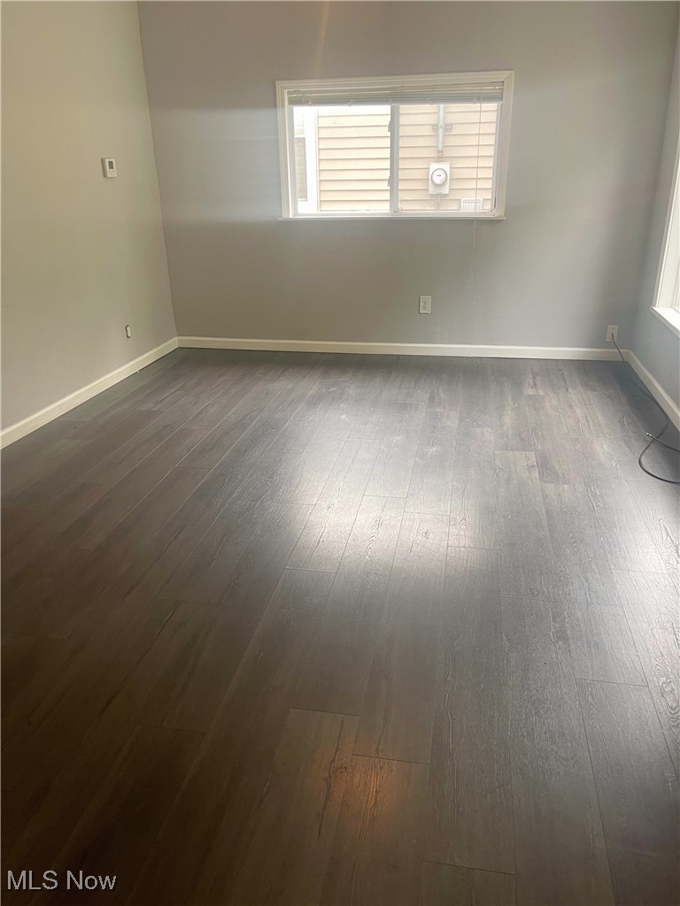 1053 Inman Street Akron, OH 44306 - Photo 3 of 17 Unfurnished room featuring dark hardwood / wood-style flooring