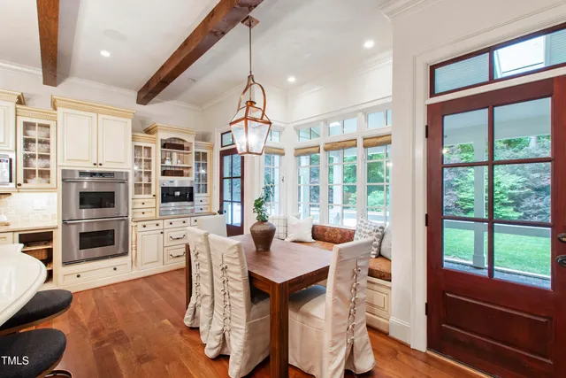 a living room with furniture a fireplace and a large window