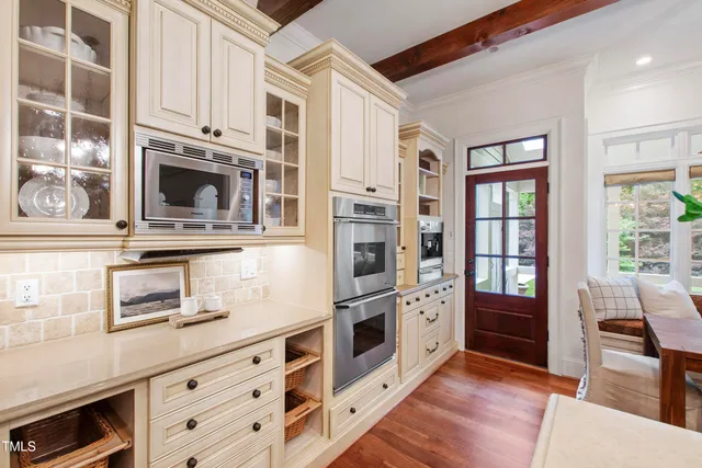 a living room with furniture a chandelier and a fireplace