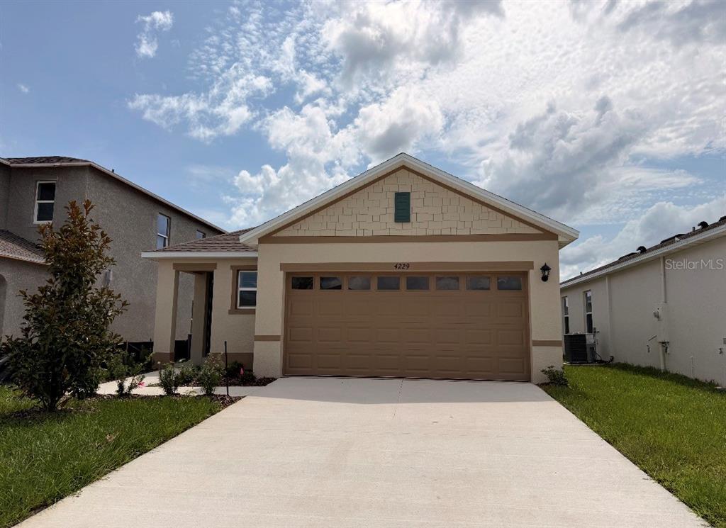 4229 Evernia Road Tavares, FL 32778 - Photo 10 of 10 a front view of a house with a yard and garage