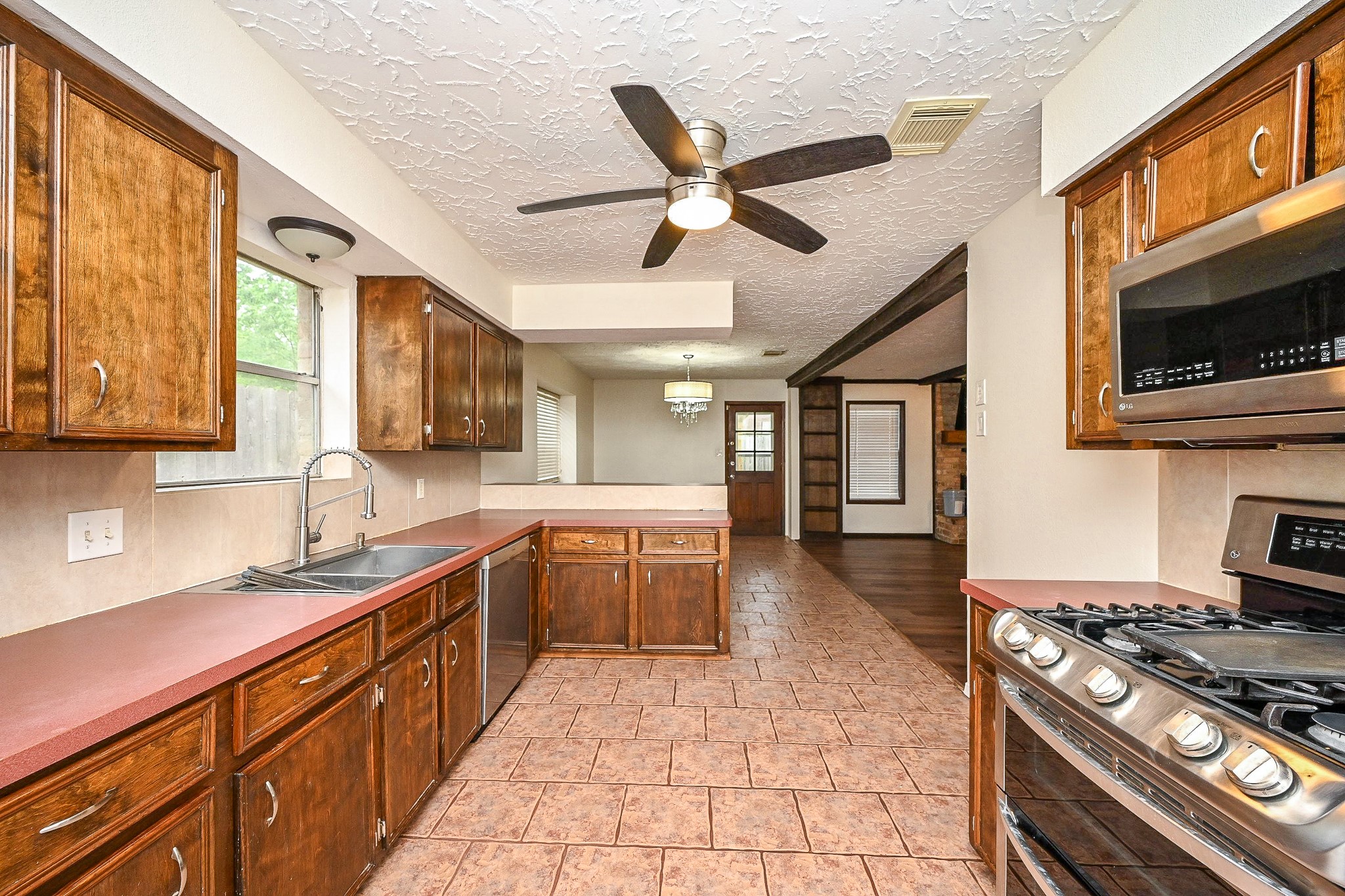 23814 Spring Gum Drive Spring, TX 77373 - Photo 5 of 21 a kitchen with stainless steel appliances granite countertop a sink and stove top oven