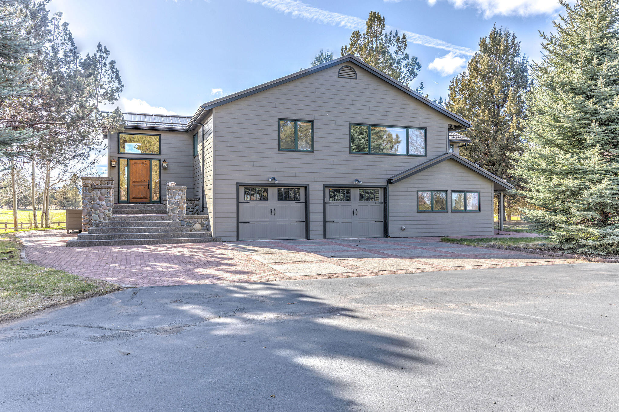60975 Billadeau Road Bend, OR 97702 - Photo 8 of 65 a front view of a house with a yard