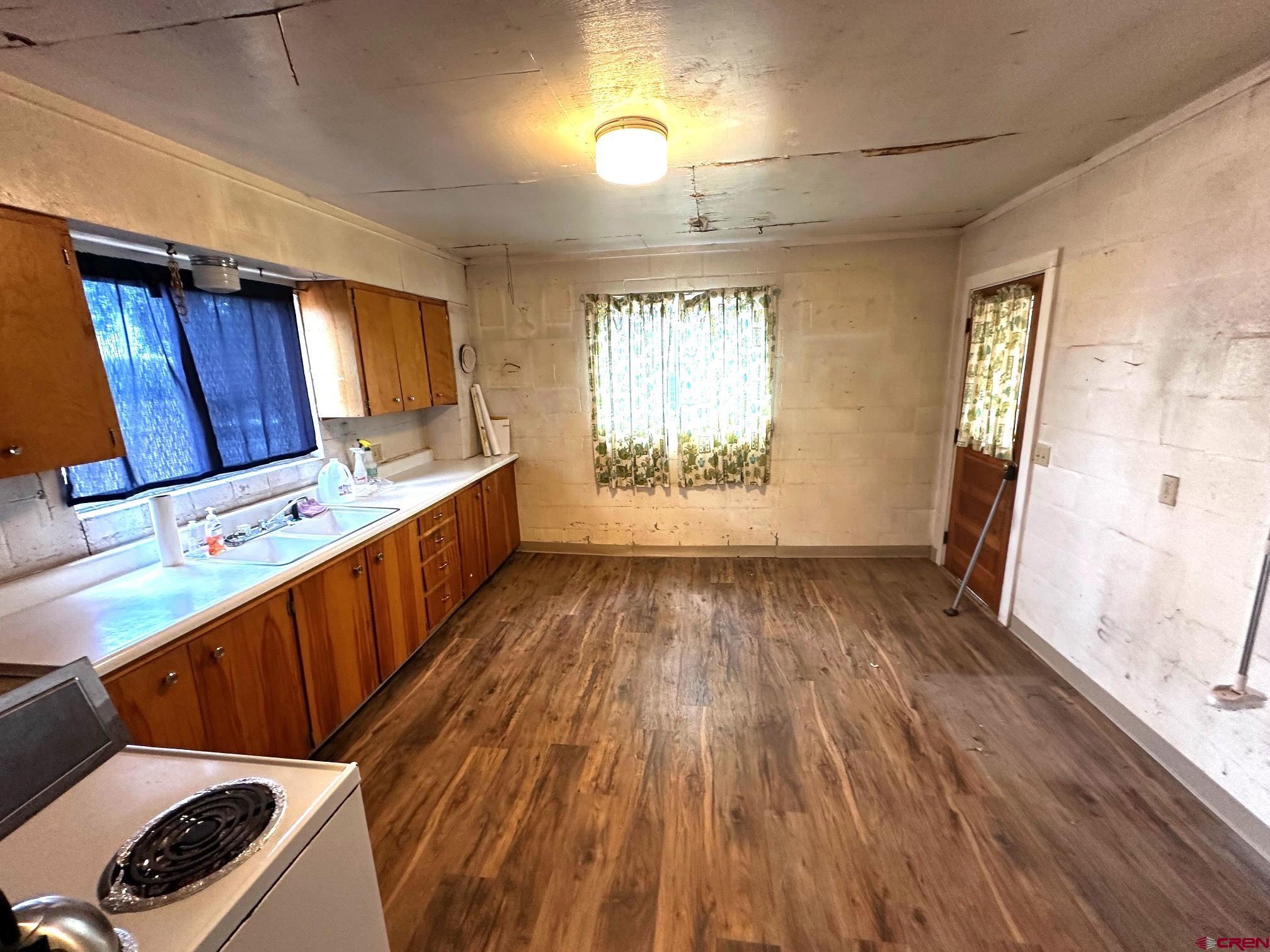 417 South Oak Street Cortez, CO 81321 - Photo 16 of 25 a kitchen with wooden floors and sink