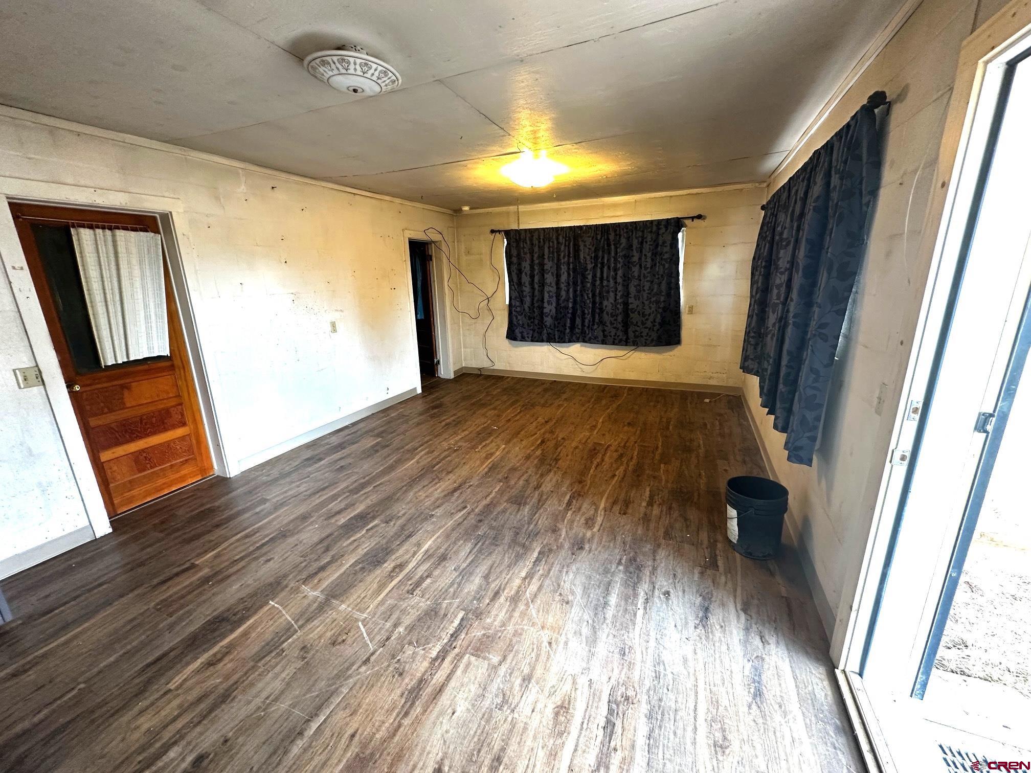 417 South Oak Street Cortez, CO 81321 - Photo 19 of 25 a view of empty room with wooden floor and fan