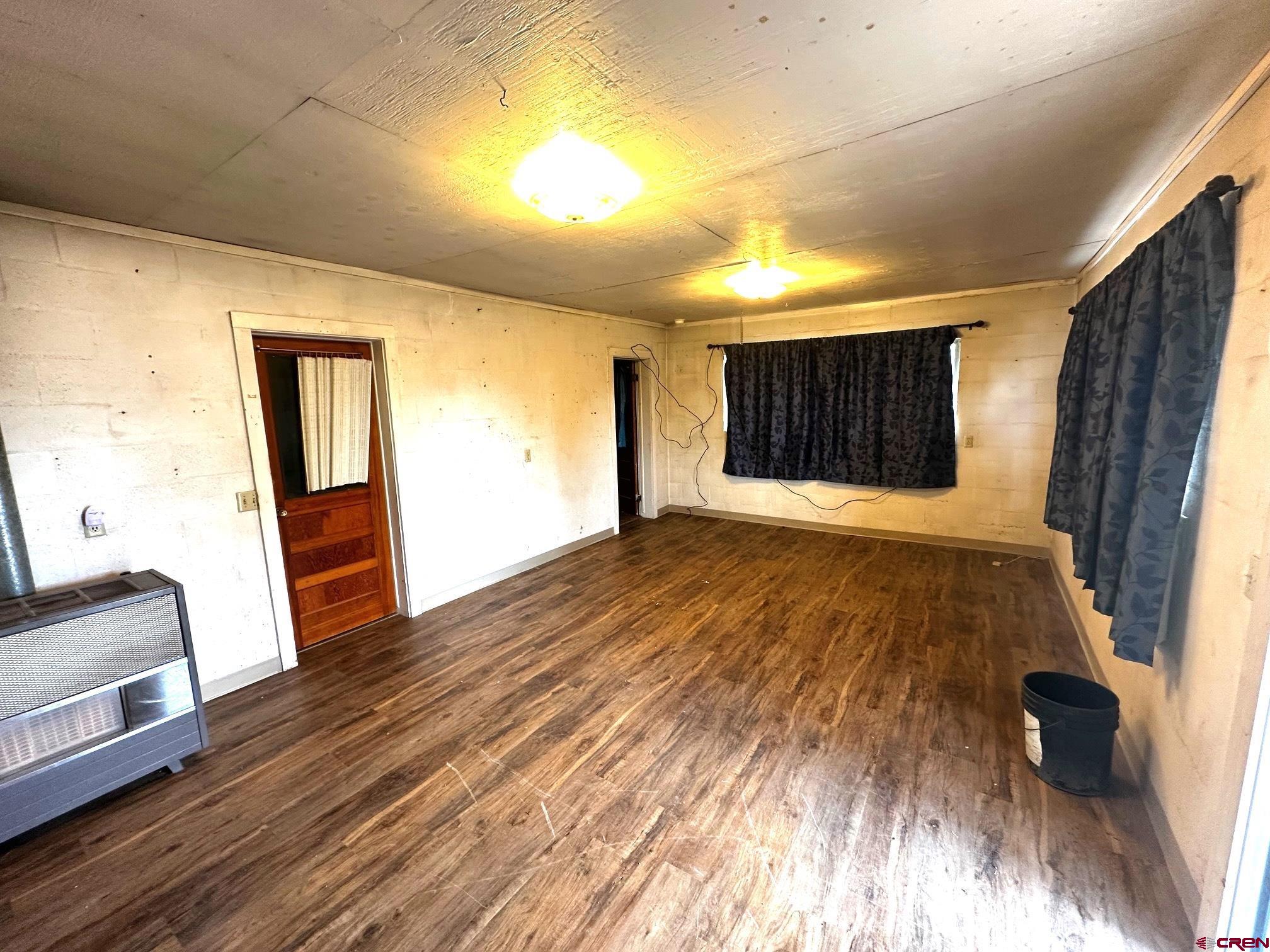 417 South Oak Street Cortez, CO 81321 - Photo 20 of 25 a view of an empty room with wooden floor and a window