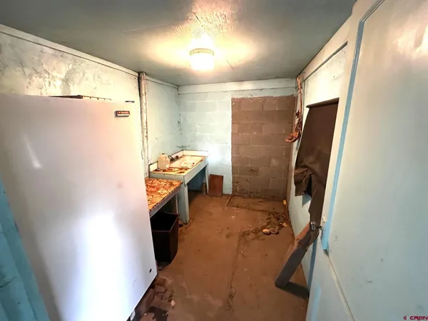 a bathroom with a sink a toilet a mirror and shower