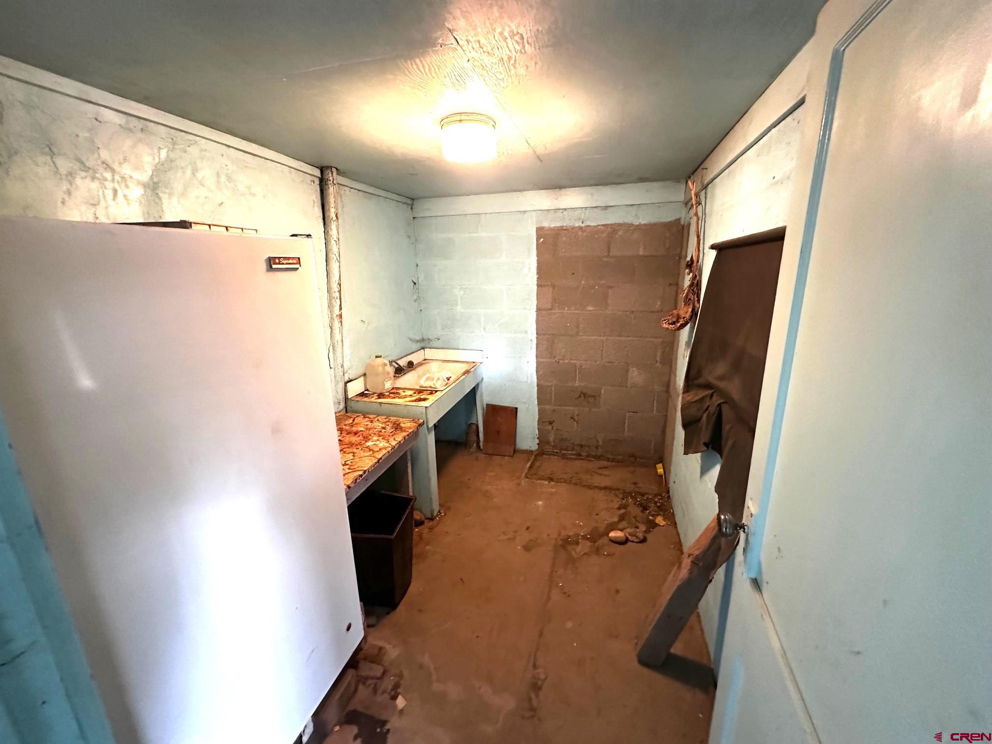 417 South Oak Street Cortez, CO 81321 - Photo 2 of 25 a bathroom with a sink a toilet a mirror and shower