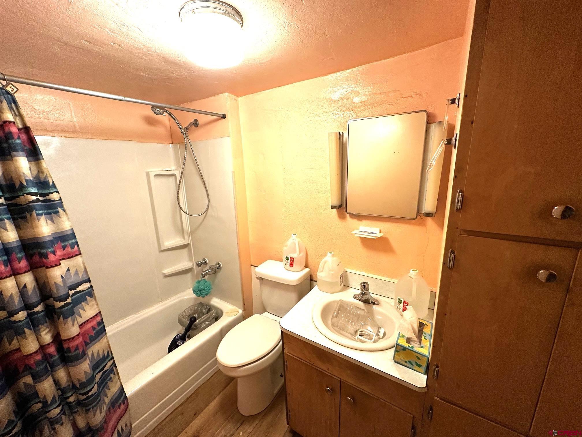 417 South Oak Street Cortez, CO 81321 - Photo 25 of 25 a bathroom with a sink toilet and shower