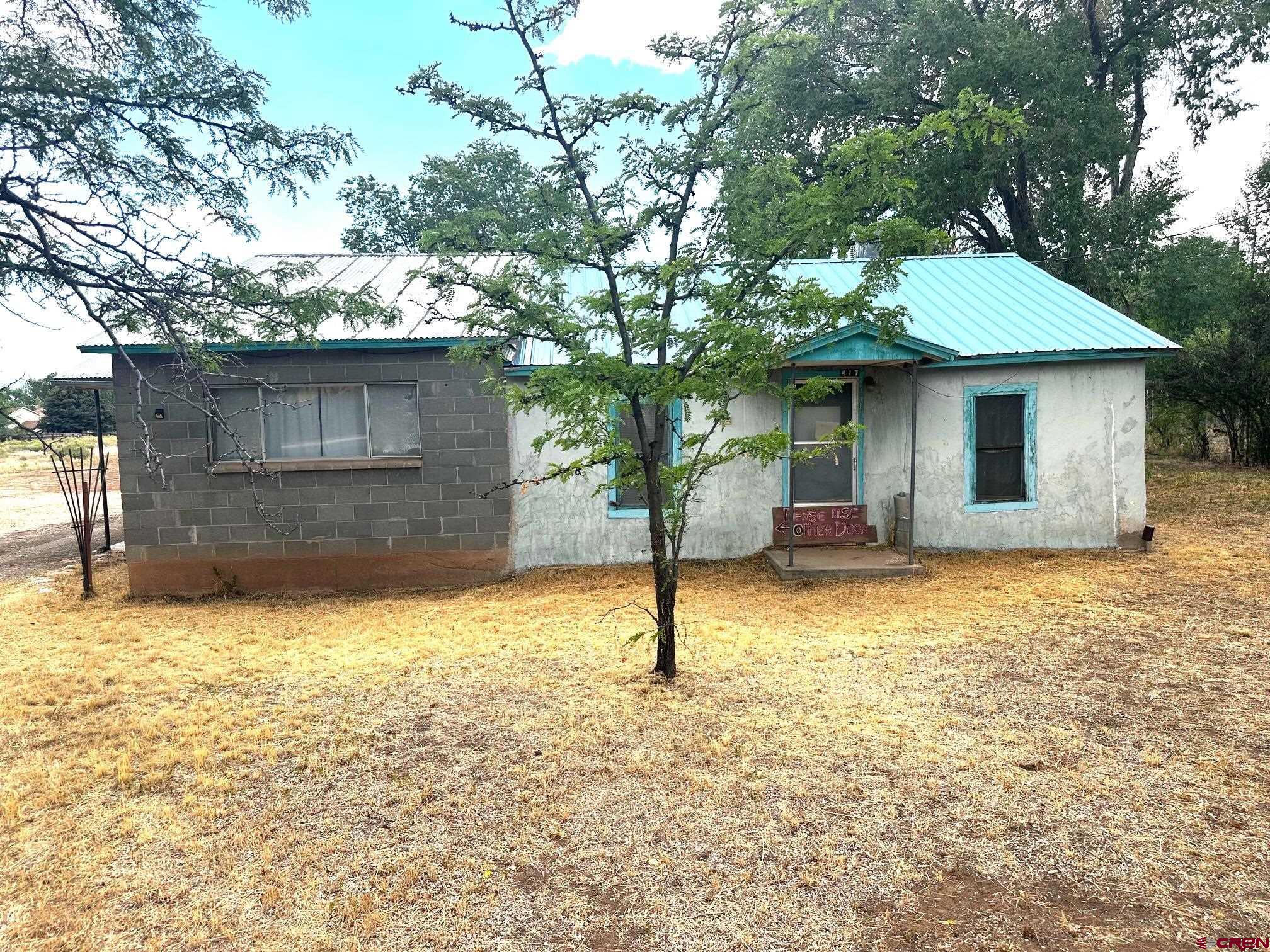 417 South Oak Street Cortez, CO 81321 - Photo 3 of 25 a backyard of a house with yard and garage