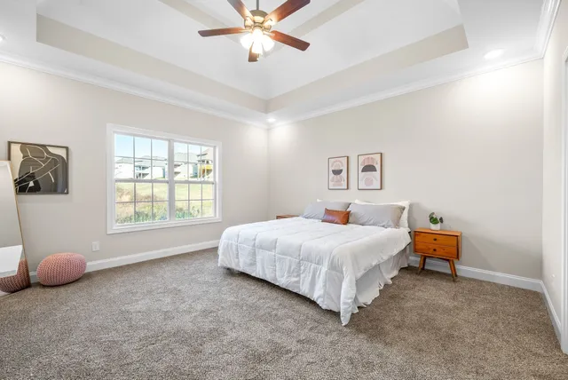 a bedroom with a bed and a chandelier