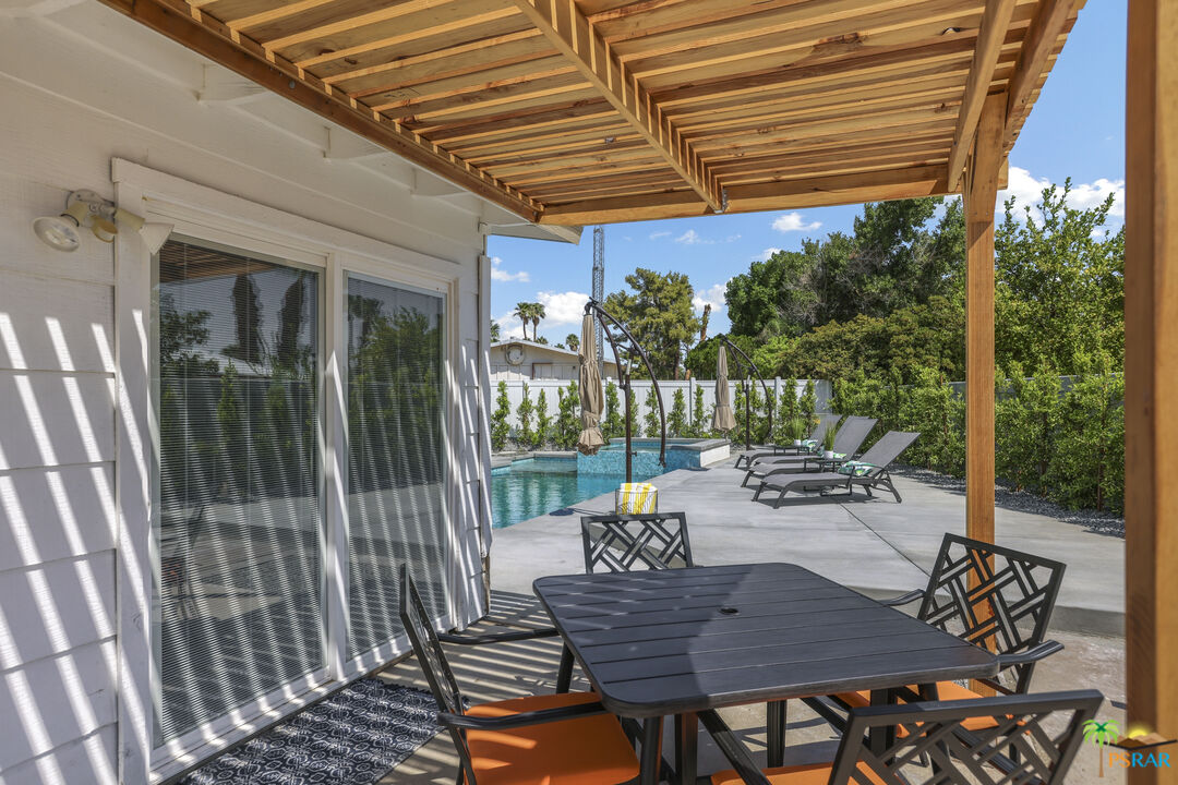 2312 North Blando Road Palm Springs, CA 92262 - Photo 21 of 27 a view of a patio with a table chairs and a backyard