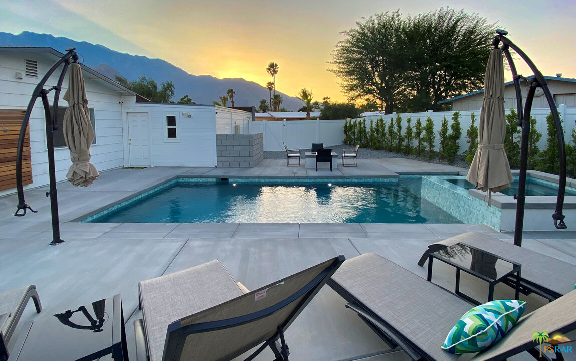 2312 North Blando Road Palm Springs, CA 92262 - Photo 27 of 27 a view of a patio with table and chairs with wooden floor and fence