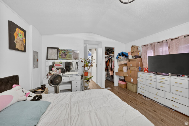 262 Hidden View Drive, Unit 94 Sandy, UT 84070 - Photo 10 of 18 Bedroom with dark wood finished floors, a walk in closet, and lofted ceiling