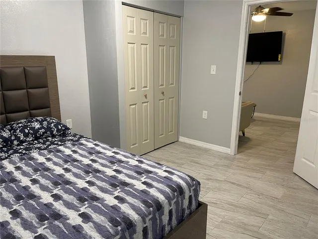 a bedroom with a bed and a television