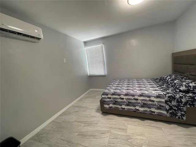 a bedroom with a bed and a window