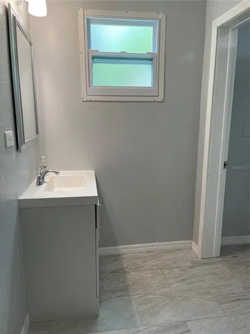 a bathroom with a sink vanity and a mirror