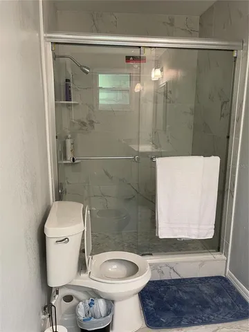 a bathroom with a toilet a sink and a shower