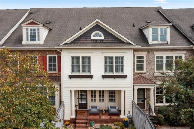 a front view of a house with a yard and balcony