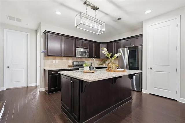 an empty room with windows and ceiling fan