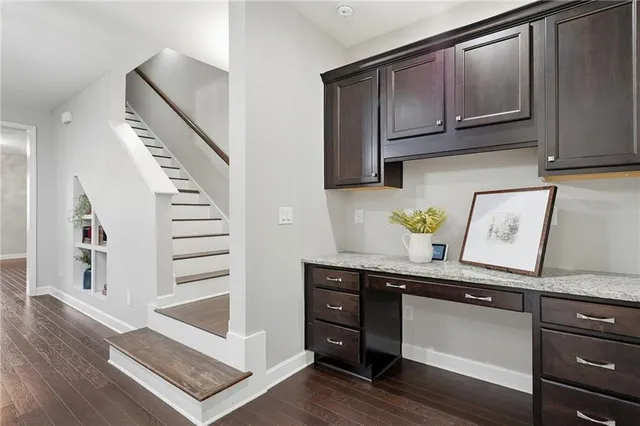 an empty room with windows and ceiling fan