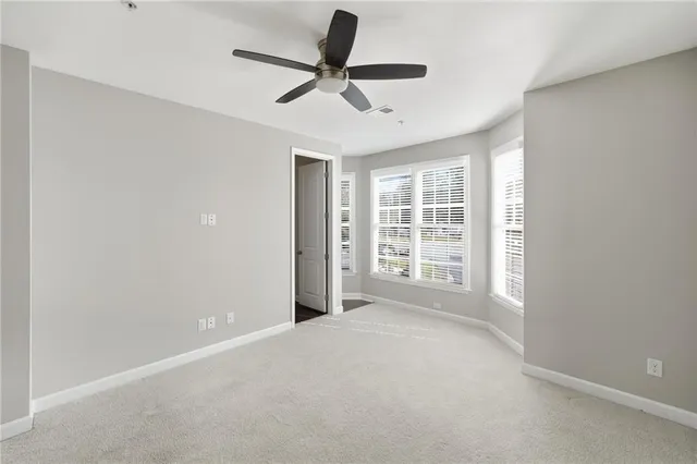 a living room with a floor to ceiling window and a table