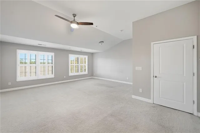 a front view of a building and car parked