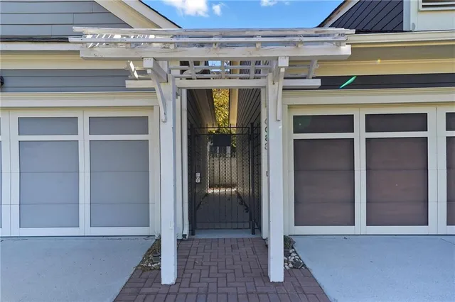 a view of an empty room with wooden floor fireplace and a window