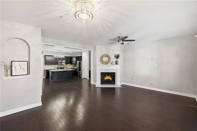 a kitchen with stainless steel appliances granite countertop a refrigerator a sink a stove and wooden cabinets