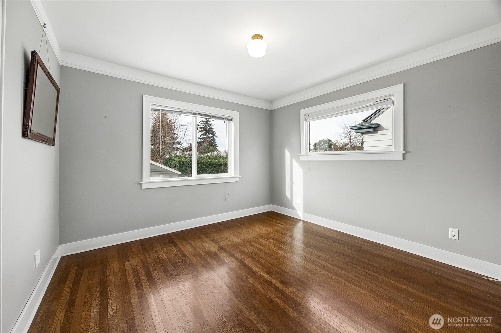2819 Northwest 68th Street Seattle, WA 98117 - Photo 12 of 39 a view of an empty room with wooden floor and a window