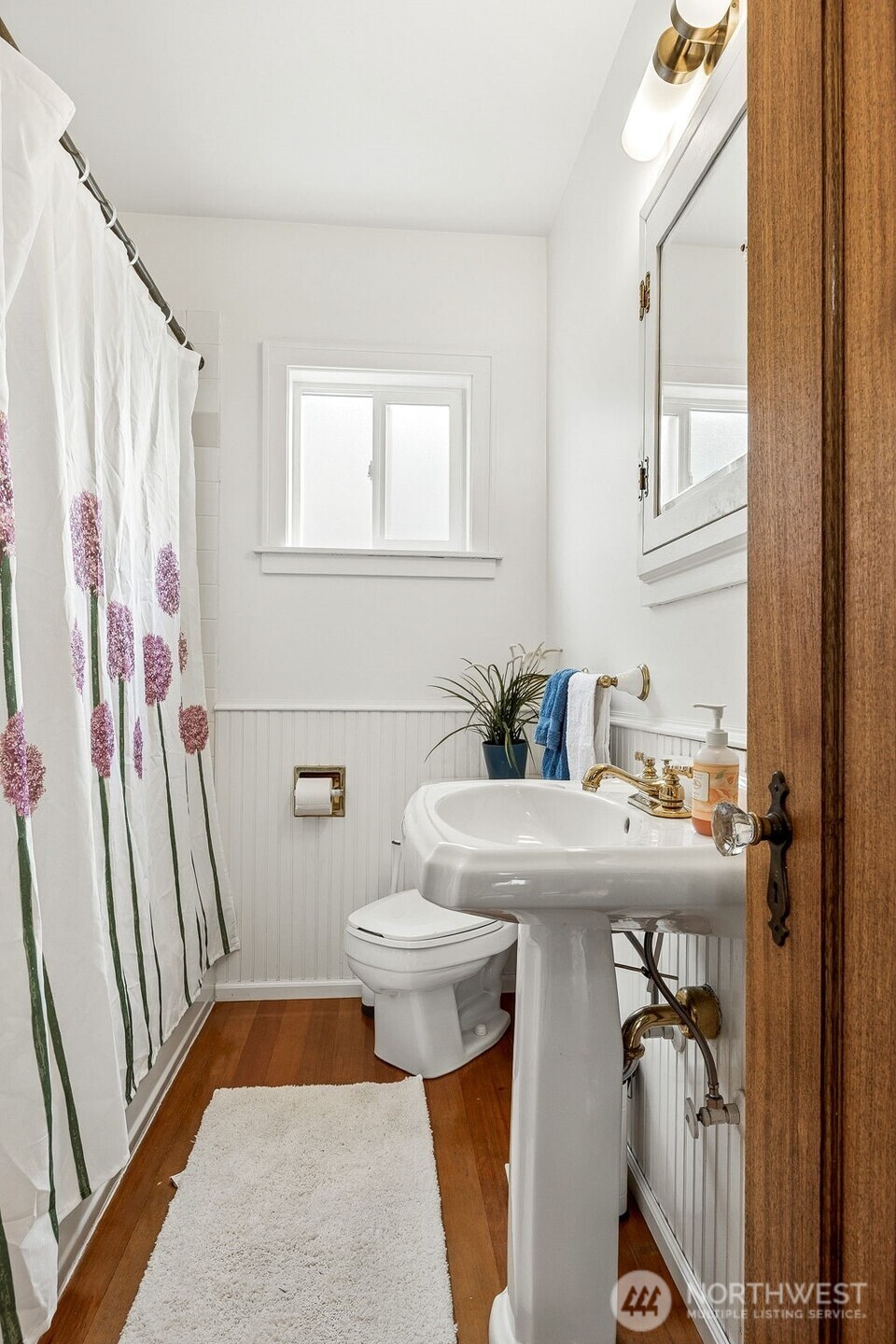 2819 Northwest 68th Street Seattle, WA 98117 - Photo 13 of 39 a bathroom with a sink a toilet and a mirror