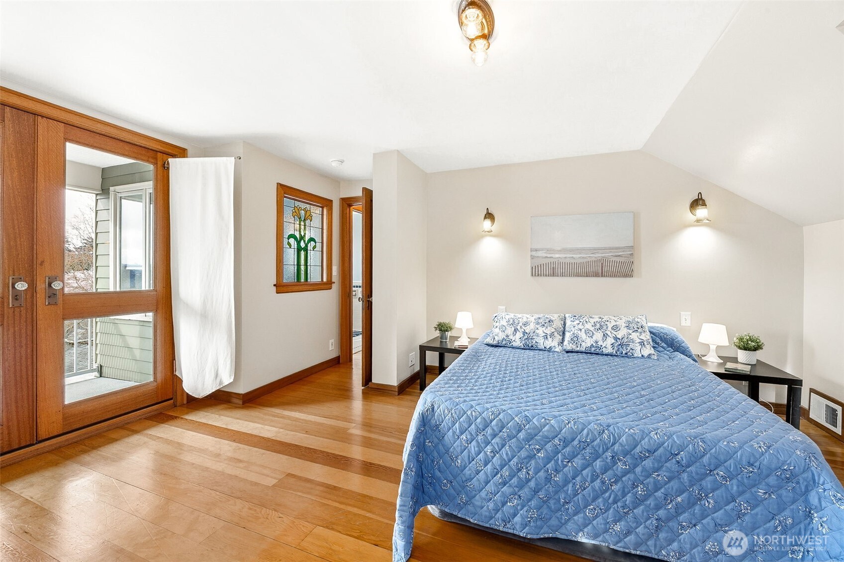 2819 Northwest 68th Street Seattle, WA 98117 - Photo 15 of 39 a bedroom with a bed and wooden floor