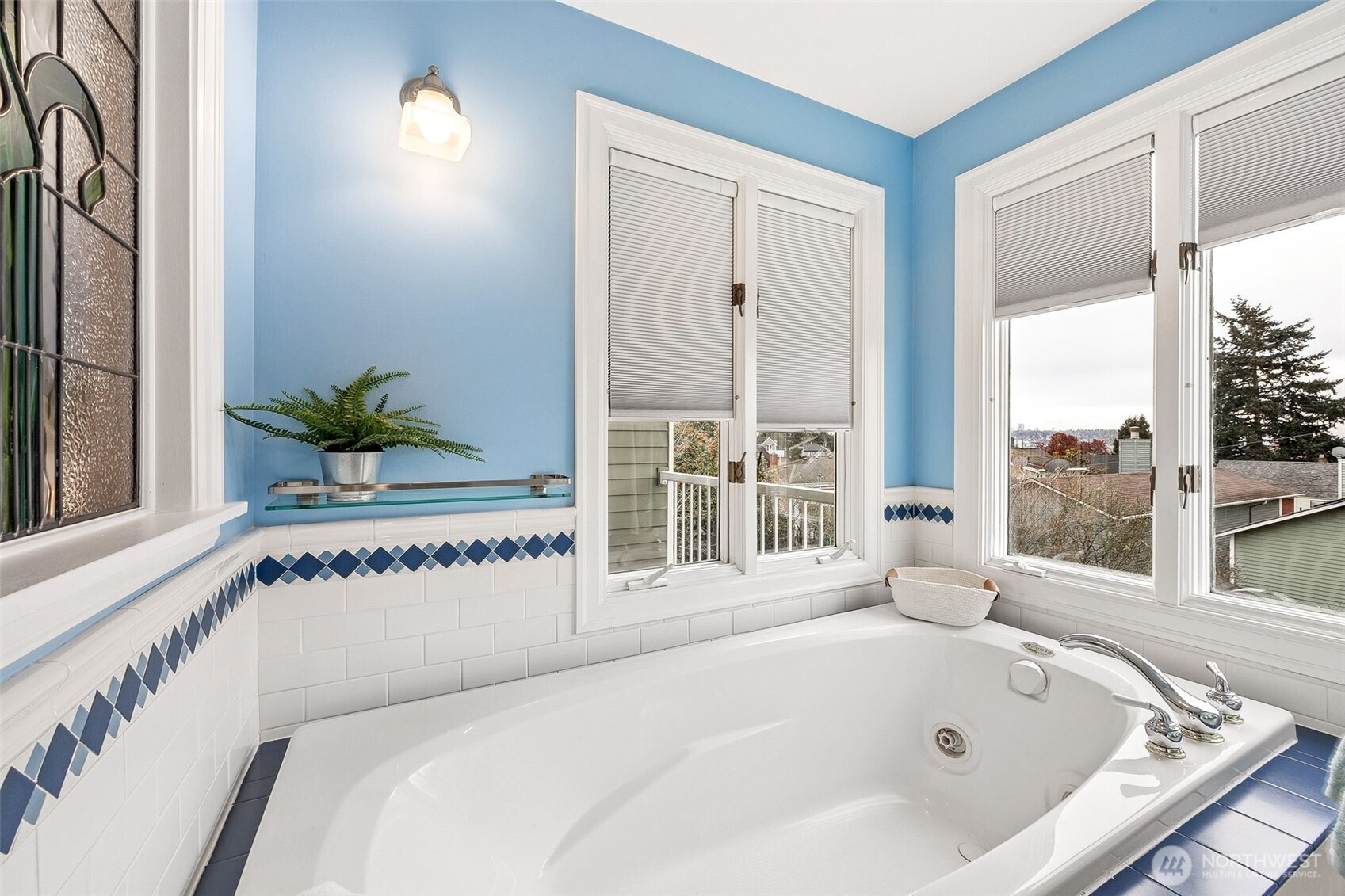 2819 Northwest 68th Street Seattle, WA 98117 - Photo 18 of 39 a white bath tub sitting in a bathroom next to a window