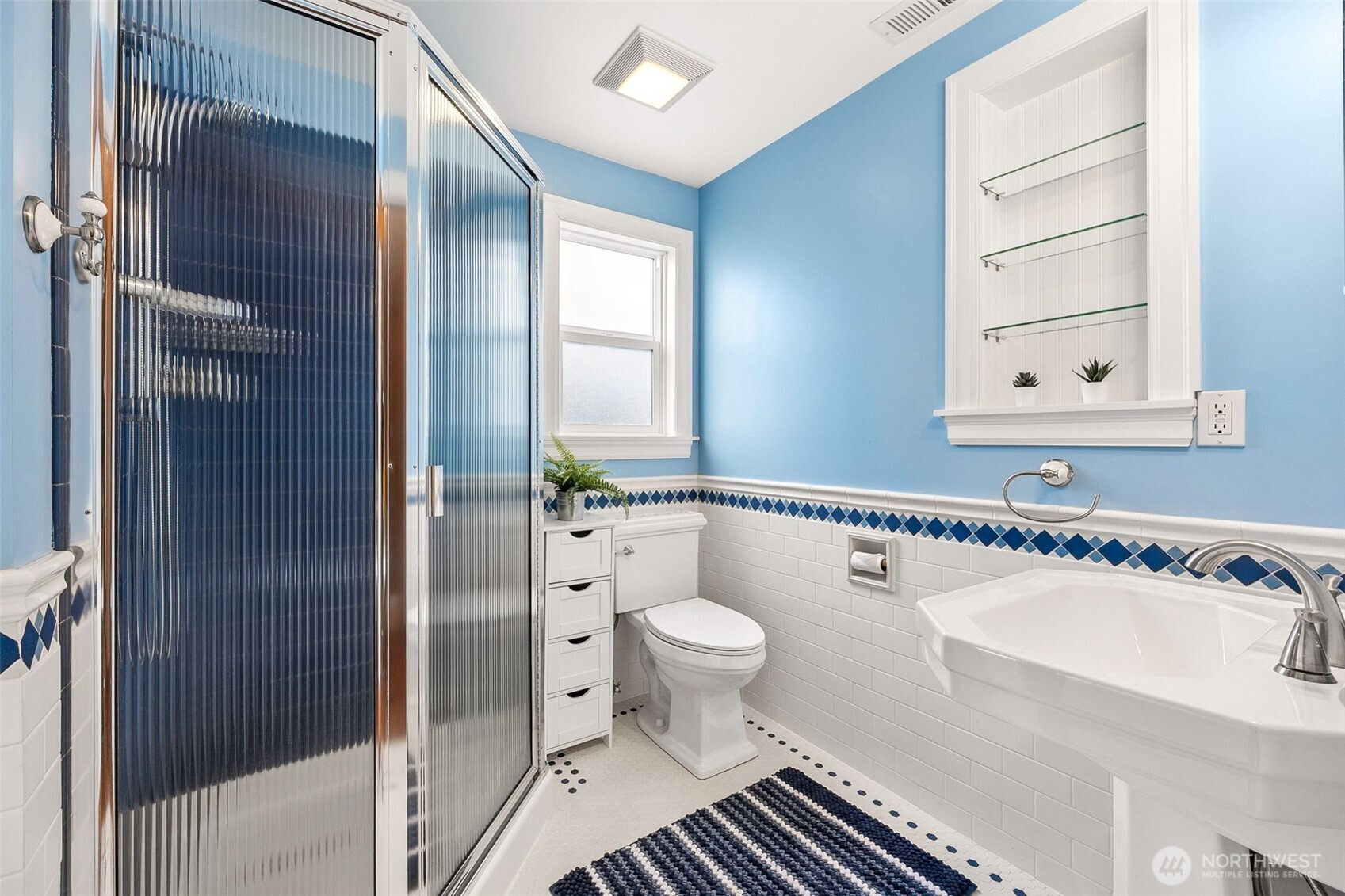 2819 Northwest 68th Street Seattle, WA 98117 - Photo 19 of 39 a bathroom with a sink a toilet and shower
