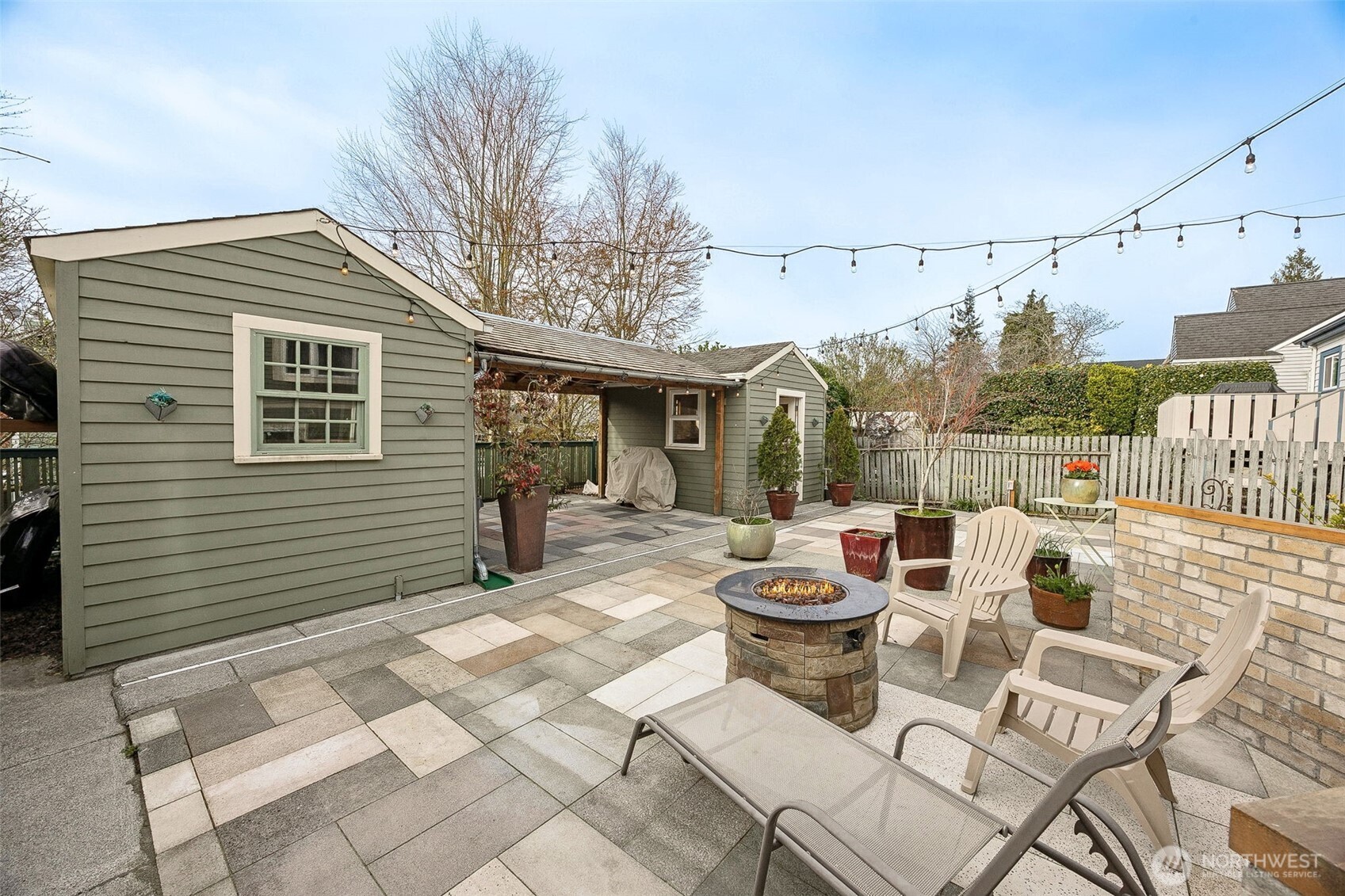 2819 Northwest 68th Street Seattle, WA 98117 - Photo 23 of 39 a view of a patio with a dining table and chairs with wooden fence