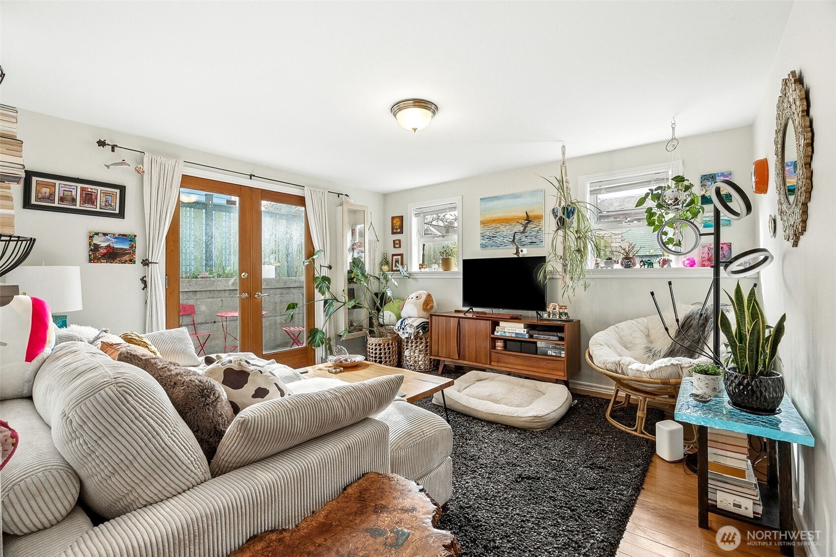 2819 Northwest 68th Street Seattle, WA 98117 - Photo 30 of 39 a living room with furniture flat screen tv and a large window