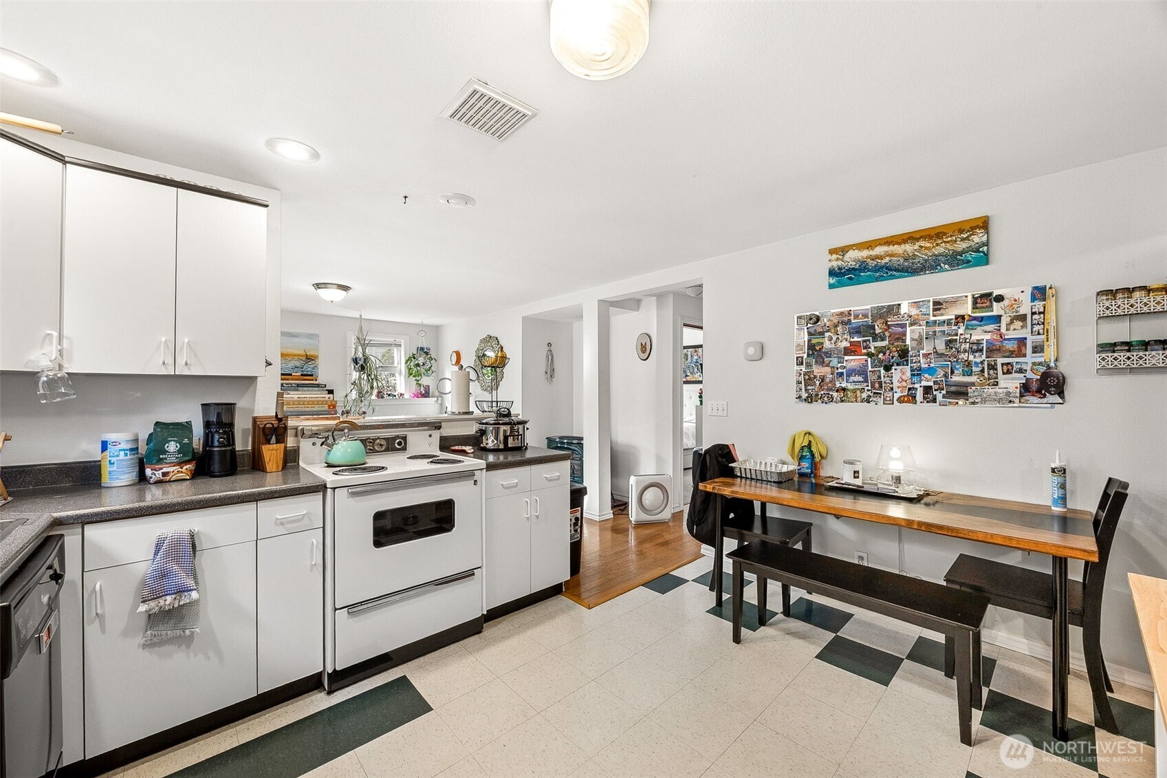 2819 Northwest 68th Street Seattle, WA 98117 - Photo 32 of 39 a kitchen with stainless steel appliances a stove a sink and white cabinets
