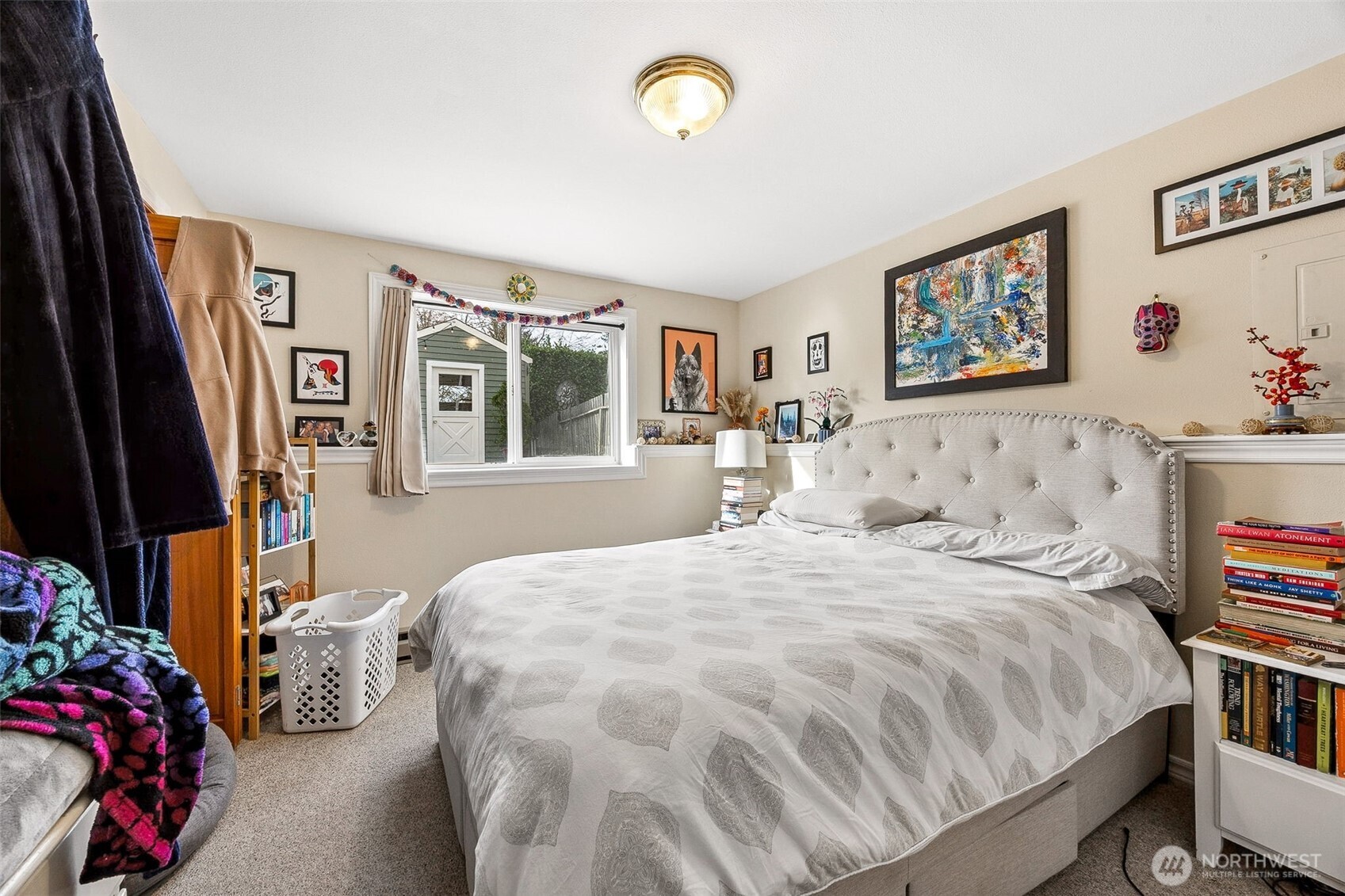 2819 Northwest 68th Street Seattle, WA 98117 - Photo 34 of 39 a bedroom with a bed painting on wall and a window