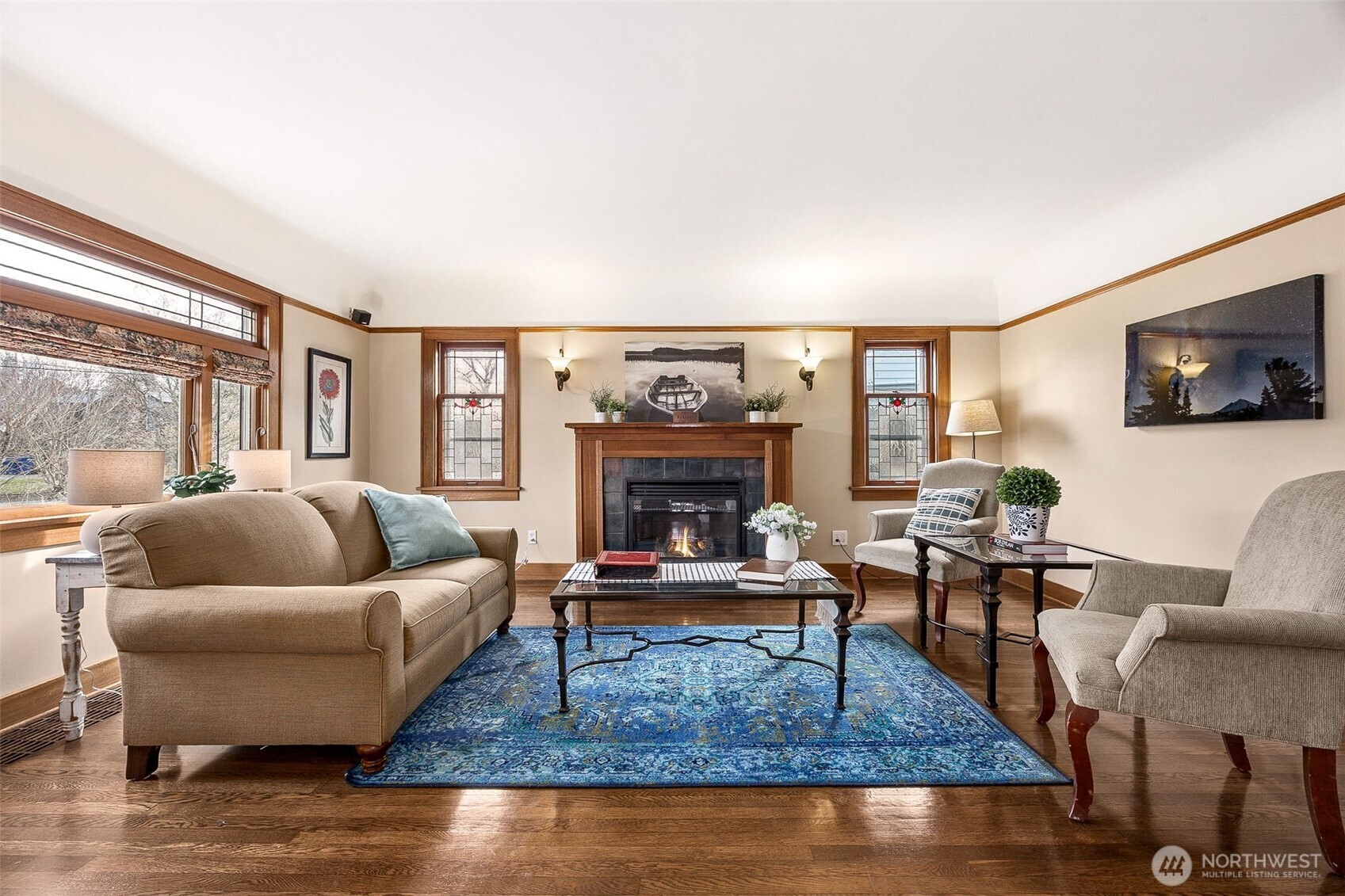 2819 Northwest 68th Street Seattle, WA 98117 - Photo 7 of 39 a living room with furniture a rug and a fireplace