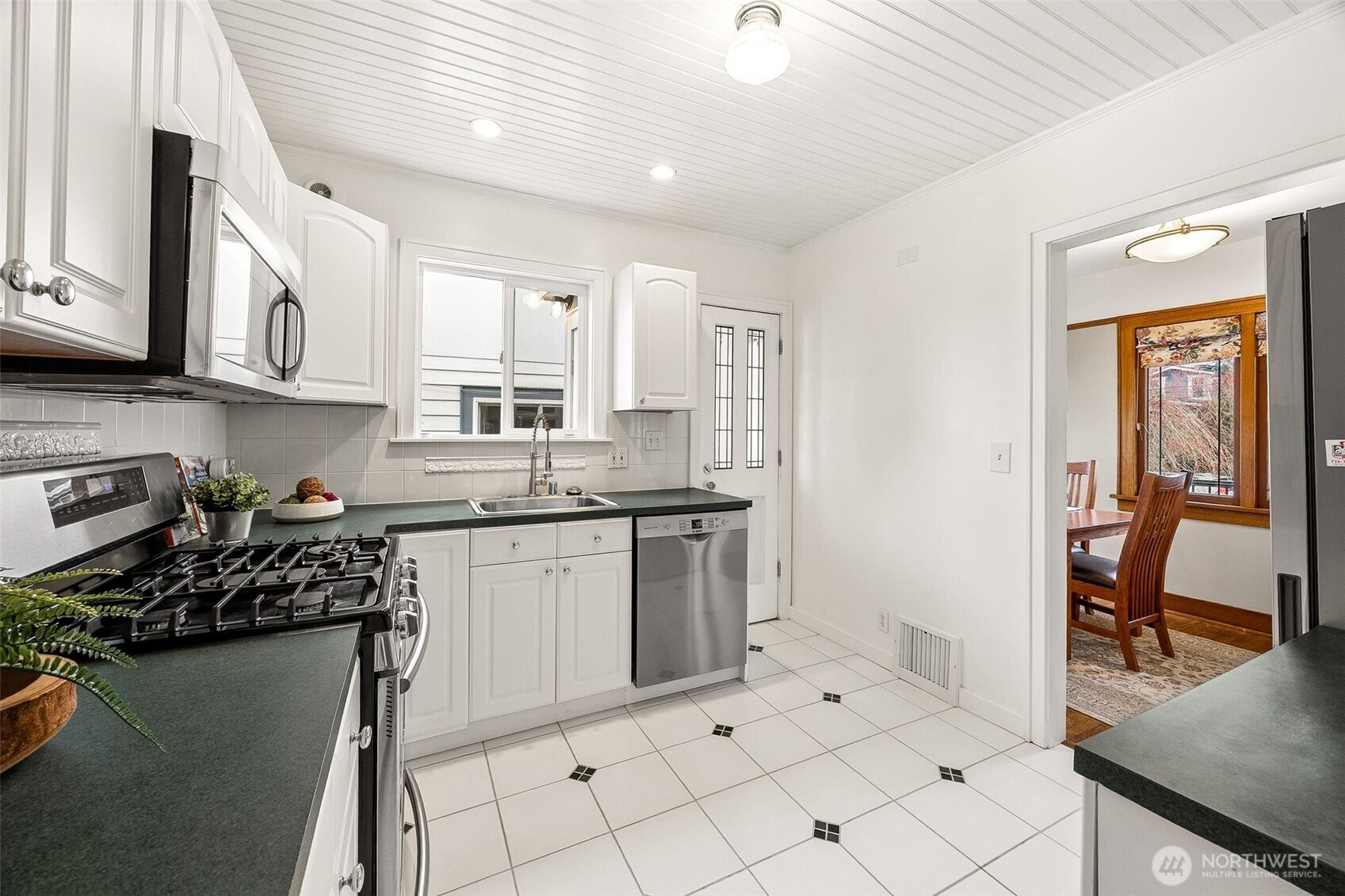 2819 Northwest 68th Street Seattle, WA 98117 - Photo 9 of 39 a kitchen with sink cabinets and stove