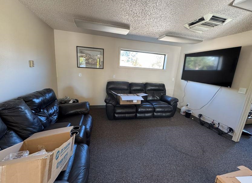 2718 Patterson Road Grand Junction, CO 81506 - Photo 11 of 13 a living room with furniture and a flat screen tv
