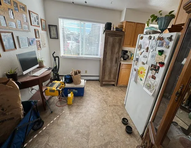 a kitchen with a refrigerator a stove top oven and a sink