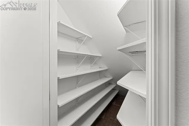 a view of a hallway with closet and wooden floor