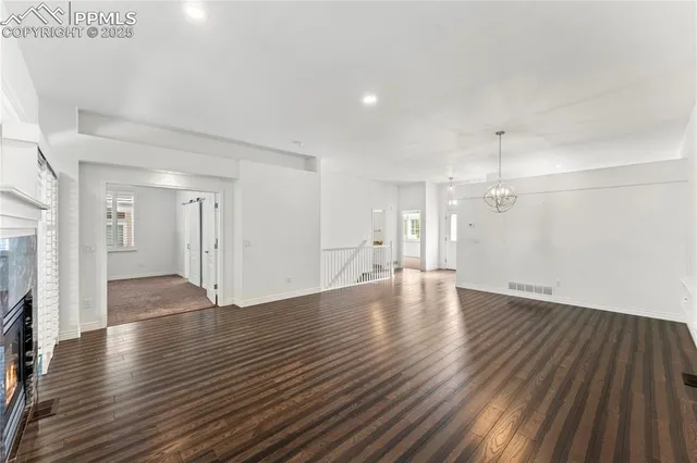 a view of a dining room with furniture wooden floor and chandelier