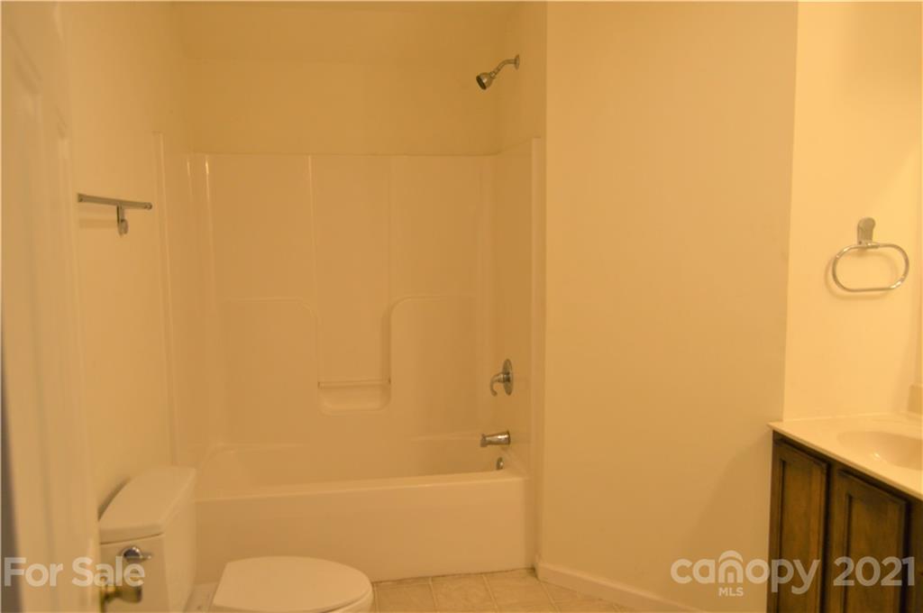 10835 Cool Springs Road Woodleaf, NC 27054 - Photo 24 of 35 a bathroom with a granite countertop shower and a toilet