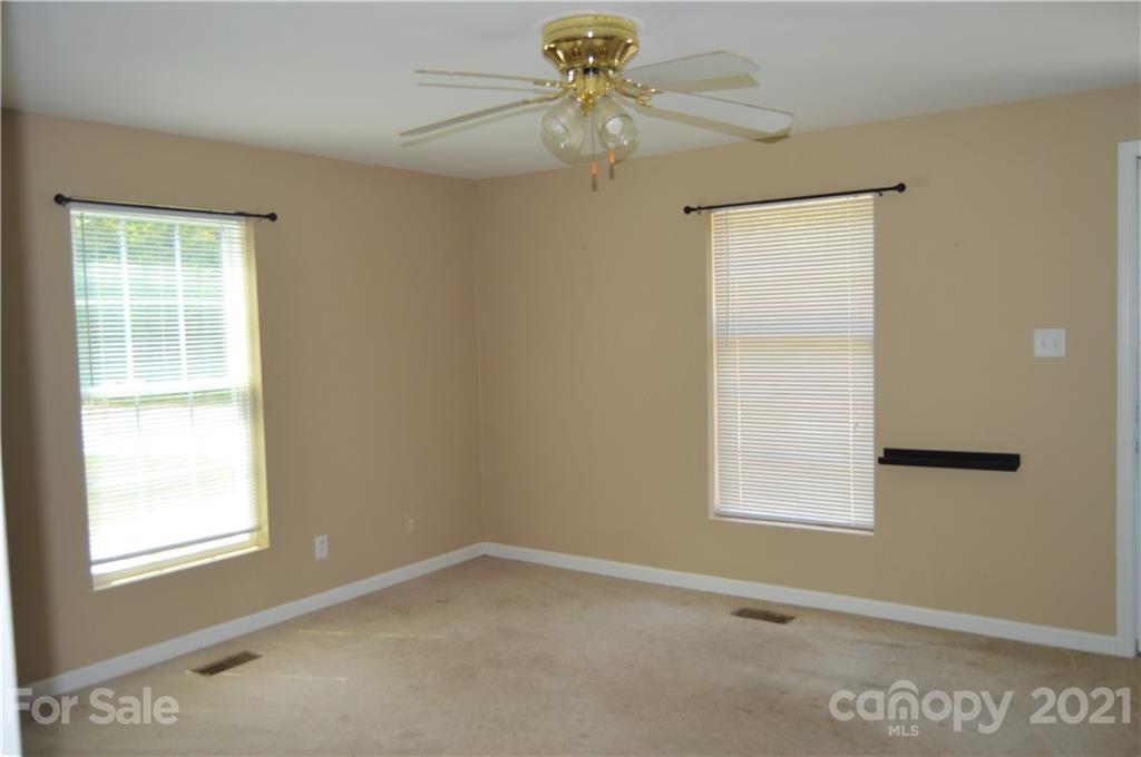 10835 Cool Springs Road Woodleaf, NC 27054 - Photo 5 of 35 an empty room with windows and fan
