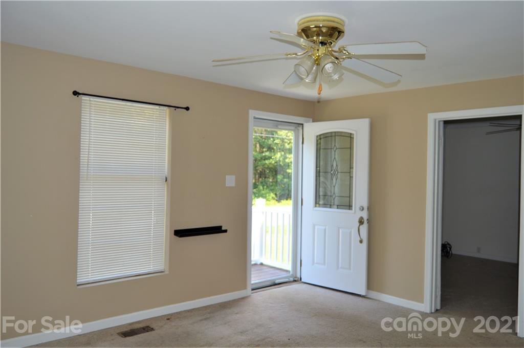 10835 Cool Springs Road Woodleaf, NC 27054 - Photo 6 of 35 a view of a bedroom with a chandelier fan and windows